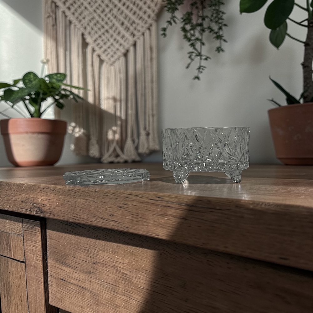Cut glass canister styled on a timber dresser with plants and macramé